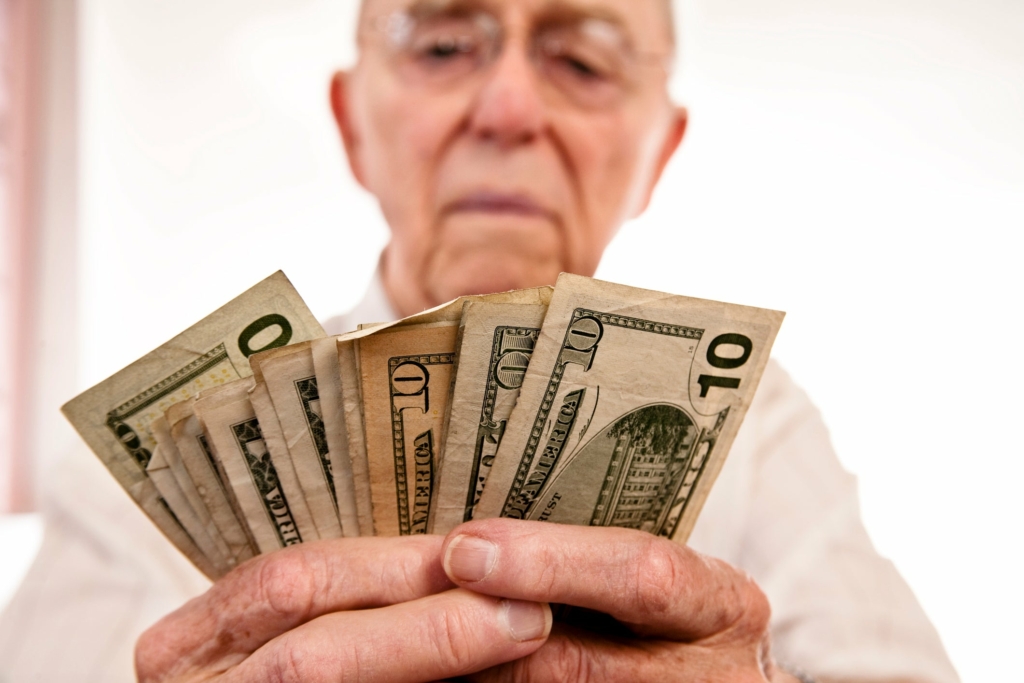 senior-fanning-cash-retirement-social-security-getty